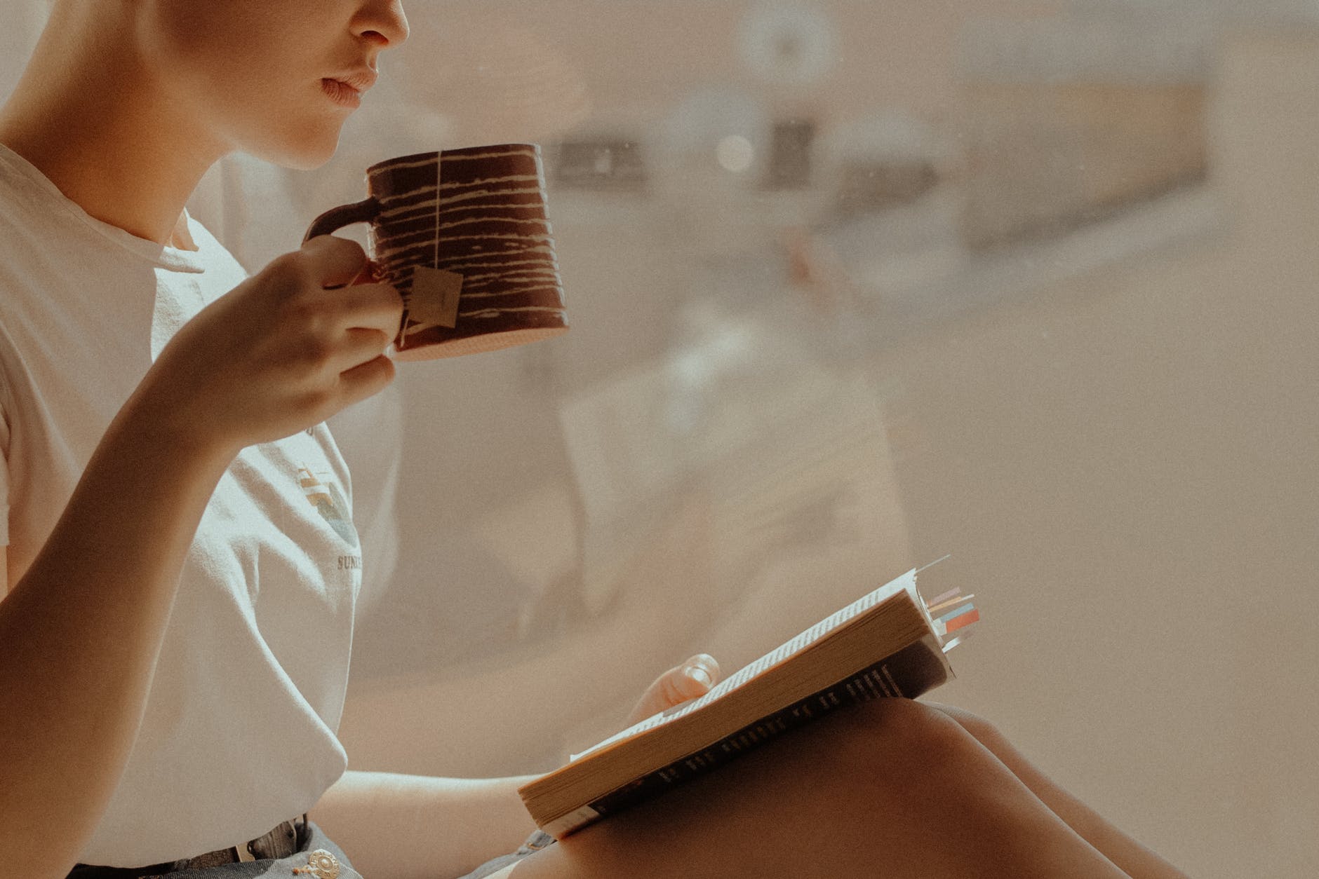 woman in white shirt reading book
